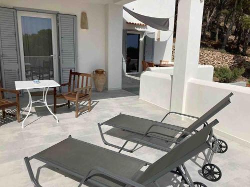 a patio with a table and chairs and a table at Dimora delle Tonnare in Favignana