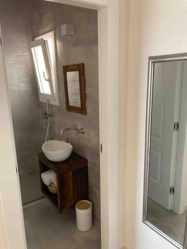 a bathroom with a sink and a mirror at Dimora delle Tonnare in Favignana