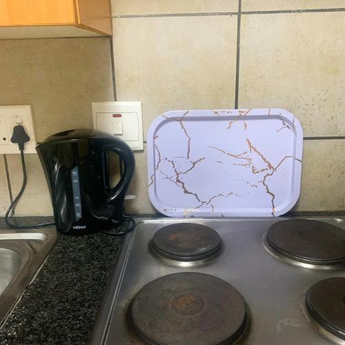 a suitcase sitting on top of a stove in a kitchen at Tintswalo Nests in Johannesburg
