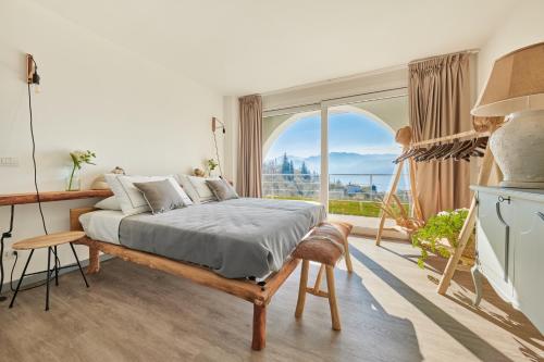 a bedroom with a bed and a large window at Villa Paier Relais & Pool in Malcesine