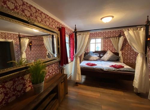 a bedroom with a bed and a large mirror at Appartement Altstadt, Gasthaus Hirsch in Hirschhorn