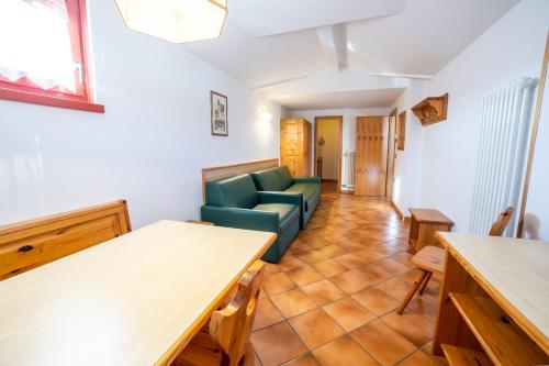 a living room with a couch and a table at Residence Derby Club in Folgaria