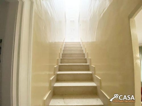 a stairway leading up to a room with stairs at Casa Costantinopoli in Padula