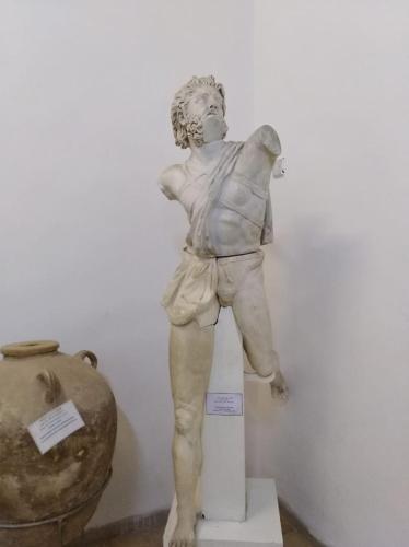 a statue of a boy standing on a pedestal at Aitch Boutique Hotel - an LIH Hotel in Madaba