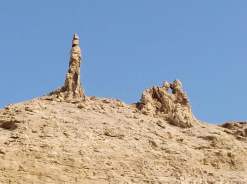 a rock formation in the desert with a blue sky at Aitch Boutique Hotel - an LIH Hotel in Madaba