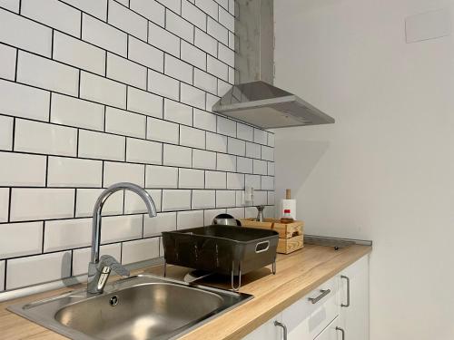 a kitchen with a sink and a stove at Suites La Catedral in León