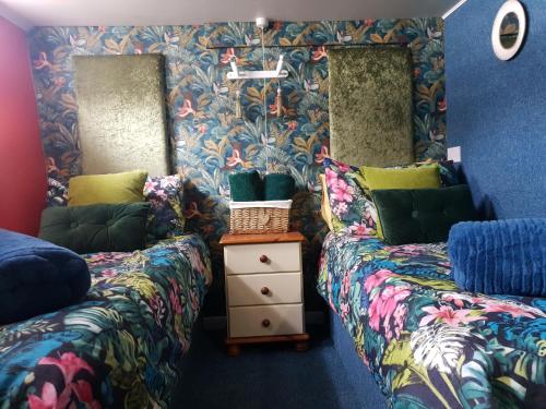 two beds sitting next to each other in a room at JASMINE CORAL JAY Boutique Boatel Ocean Village in Gibraltar