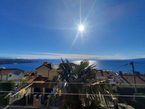 a view of a city with the sun in the sky at MORABEZA Opatija in Opatija