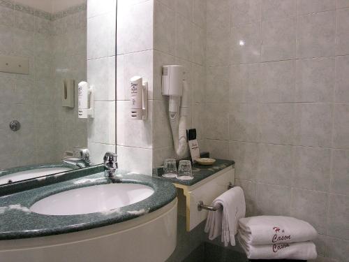 a bathroom with a sink and a toilet at Hotel Al Cason in Padova