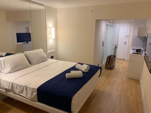 a bedroom with a large bed with two towels on it at Luxury Studio with Ocean View in Batumi
