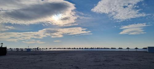 a view of a beach with a cloudy sky at The Apartments in VALAMAR in Hamallë
