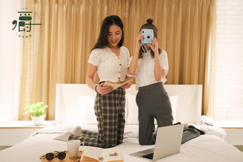 a woman taking a picture of herself in a mirror at Anho Chew Hotel in Luodong