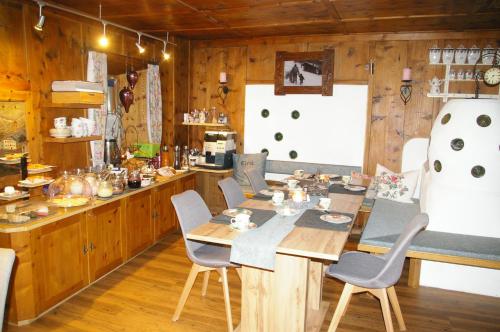 a kitchen with a table and chairs in a room at Thalerhof in Roppen