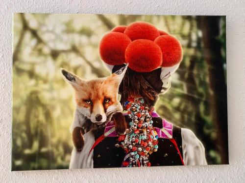 a woman with a fox on her head and wearing red hats at FeWo Fuchs Saig in Lenzkirch
