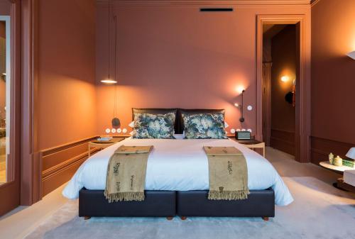 a bedroom with a large bed with two pillows at Jardins do Porto - by Unlock Hotels in Porto