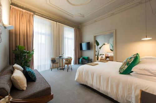a hotel room with a bed and a table at Jardins do Porto - by Unlock Hotels in Porto