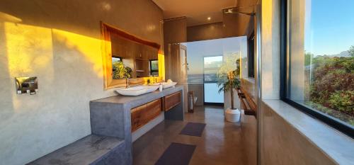 een badkamer met 2 wastafels en een groot raam bij Seebederfie in Groot Brak Rivier