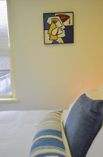 a bed with a pillow and a picture on the wall at Michie House in College Hill in Providence