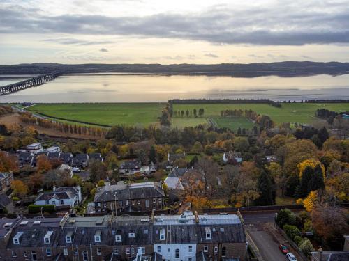 an aerial view of a town with a bridge over a lake at The Clarendon in Dundee