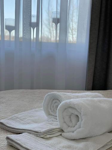 a couple of towels sitting on top of a bed at Suuremõisa Holiday Apartment with Sauna in Suuremõisa