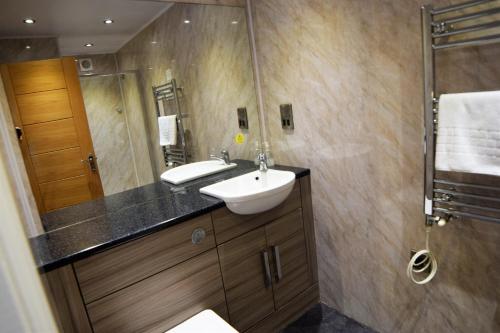 a bathroom with a sink and a shower at Dolphin Rooms in Cleethorpes