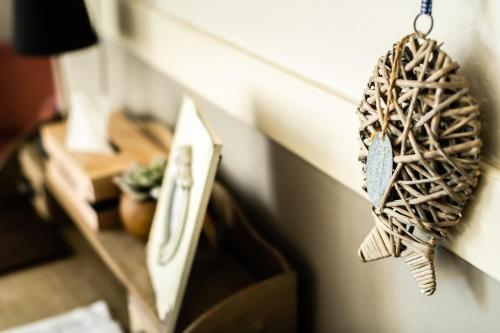 a bird ornament hanging on a wall at B&B Maison Rabelais in De Haan