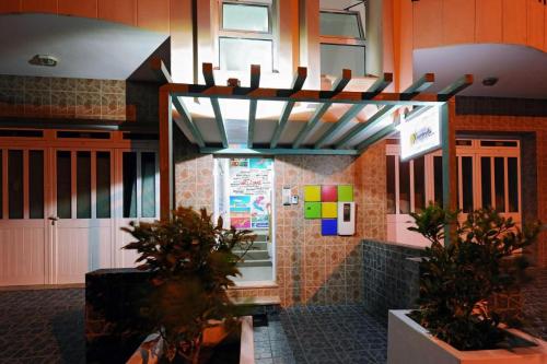 a restaurant with plants in front of a building at Atlantic Sal Hostel in Santa Maria