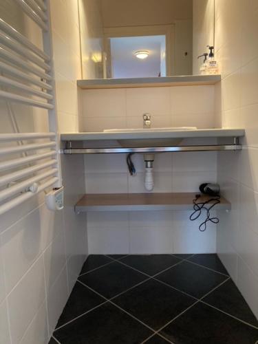 a bathroom with a sink and a mirror at Village Naturiste NATUREVA & SPA - Babylone NATURISME in Cap d'Agde