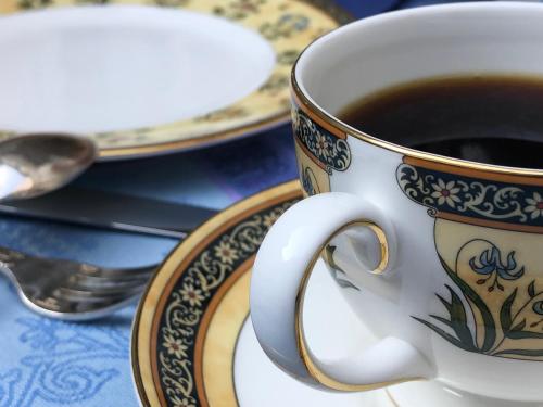 a cup of coffee sitting on a plate at Le 31 B&B Amboise Centre in Amboise