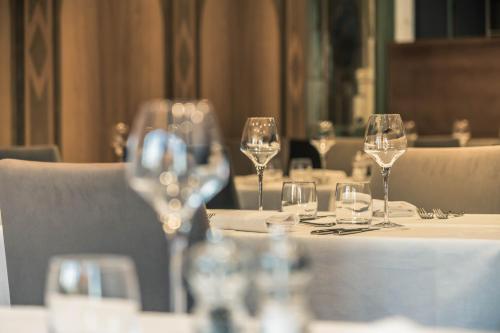a group of wine glasses sitting on a table at Hotel Spa et Restaurant Au Chasseur in Birkenwald