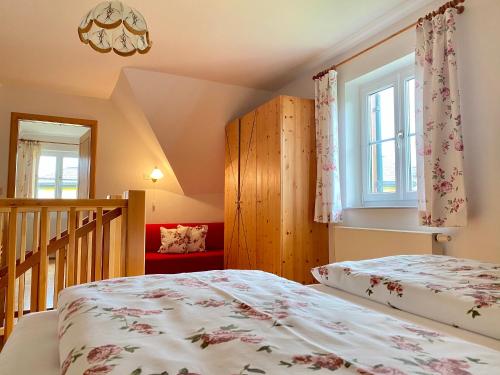 a bedroom with a bed and a staircase at Landhaus Bender Ferienwohnung mit Terrasse und Garten in Straden