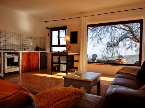 a living room with a couch and a large window at Apartamento Pirul in Haría