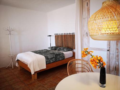 a bedroom with a bed and a table at Apartamento Pirul in Haría