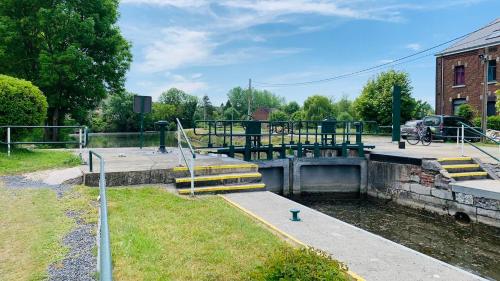 a lock on a canal with steps in the water at Domaine de falimont à Labuissière in Merbes-le-Château