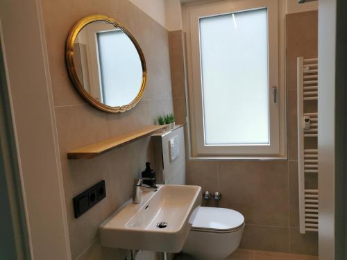 a bathroom with a sink and a toilet and a mirror at Am Grimming 14 in Tauplitz