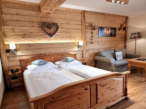a bedroom with a large bed and a couch at Seehotel Hartung & Ferienappartements in Füssen