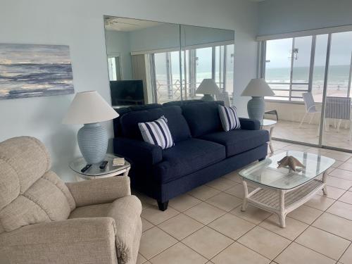 a living room with a blue couch and a table at Island House Beach Resort 5S in Siesta Key