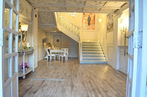 a hallway with a staircase and a table with chairs at Ares Hotel in Zamora