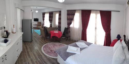 a bedroom with a large bed and a living room at Malia Holiday Let in Famagusta