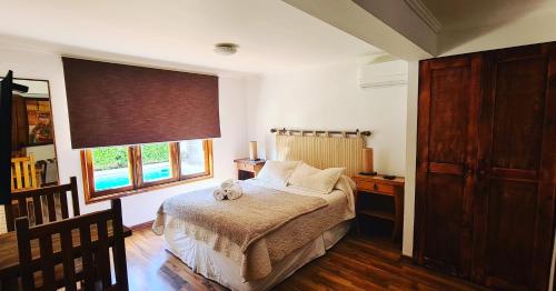 a bedroom with a bed and a large window at Tierra y Vino a metros de plaza casino y museo Colchagua in Santa Cruz