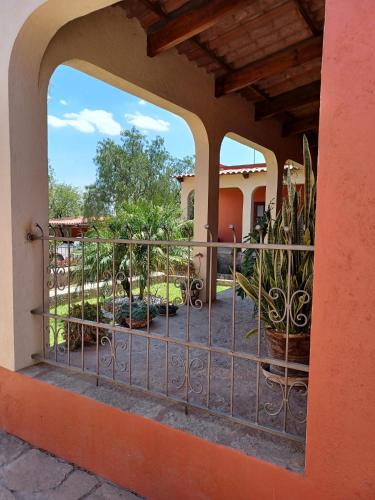 a balcony of a house with a gate and plants at CASONA DOS VIDAS in El Sauz Tequisquiapan