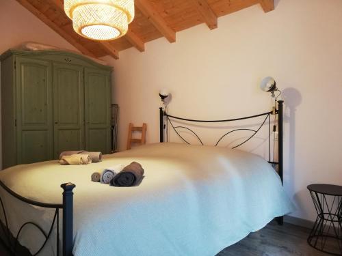 a bedroom with a large bed with a greenoire at Casa Vacanza L'Ulivo in Albenga