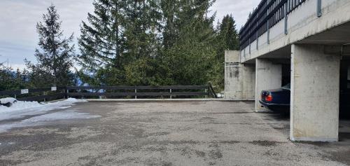 a car is parked under a bridge at 2 pièces équipé avec parking privé in Gryon