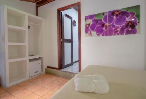 a room with a bed with a towel on it at Hotel El Jardin in Montezuma