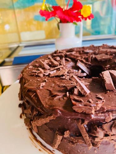 a chocolate cake sitting on top of a table at Flamboyant Residence in Fernando de Noronha