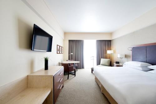 a hotel room with two beds and a television at Grand Fiesta Americana Queretaro in Querétaro