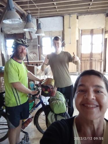 a group of three men standing next to a bike at HOSTAL CASA VICTORIA PIJAO in Pijao