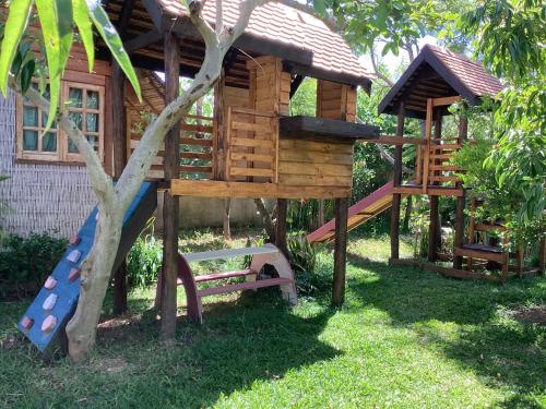 a tree house with a slide and a playground at Maison entière ChezSoa, antananarivo in Andoharanofotsy