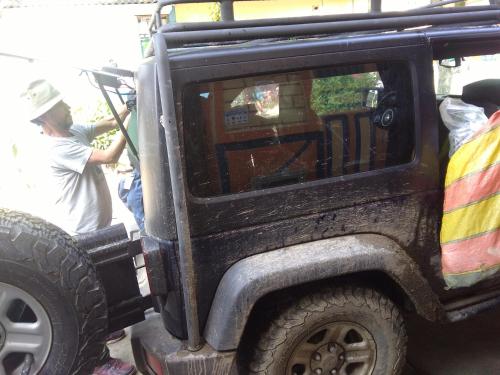 a man standing in the door of a jeep at HOSTAL CASA VICTORIA PIJAO in Pijao