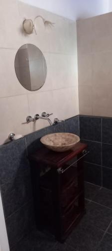 a bathroom with a sink and a mirror at Eljacaranda_ in Gualeguay